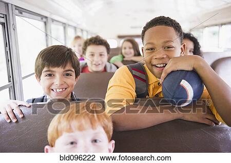 Stock Image - Children riding school bus. Fotosearch