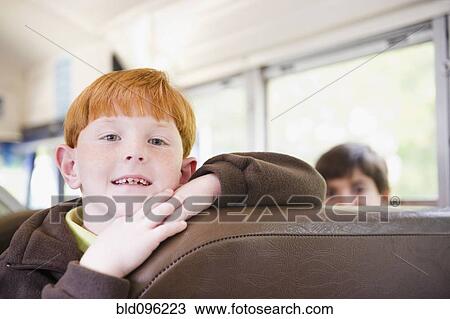 Stock Image - Children riding school bus. Fotosearch