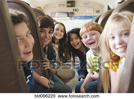 Stock Photo - Children riding school bus. Fotosearch