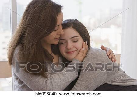 Stock Image - Chilean mother hugging daughter. Fotosearch