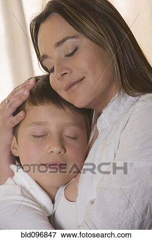 Stock Photo - Chilean mother hugging son. Fotosearch