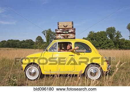 Couple in old-fashioned car on road trip View Large Photo Image Stock Image - Couple in old-fashioned car on road trip. Fotosearch
