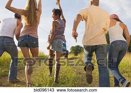 Happy friends running together in field View Large Photo Image Stock Image - Happy friends running together in field. Fotosearch