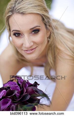 Hispanic bride holding bouquet of flowers View Large Photo Image Stock Image - Hispanic bride holding bouquet of flowers. Fotosearch