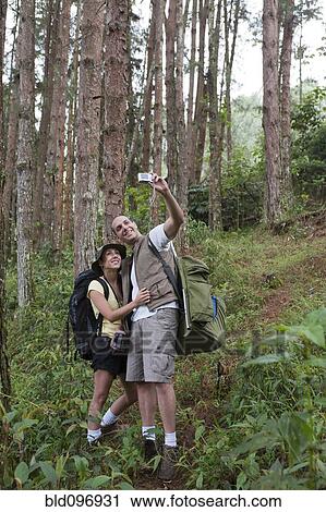 Hispanic couple hiking and taking photographs View Large Photo Image Stock Image - Hispanic couple hiking and taking photographs. Fotosearch