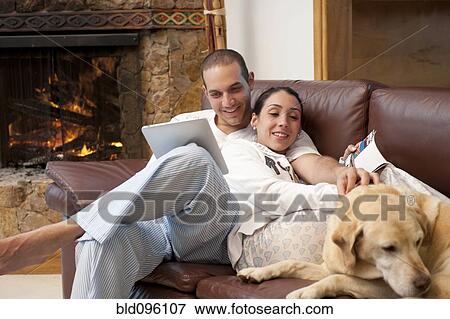 Hispanic couple relaxing on sofa together View Large Photo Image Stock Photo - Hispanic couple relaxing on sofa together. Fotosearch