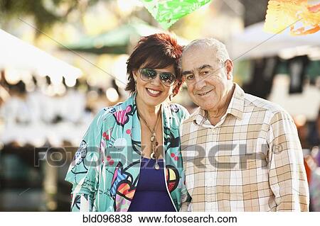 Stock Photo - Hispanic father and daughter standing outdoors. Fotosearch