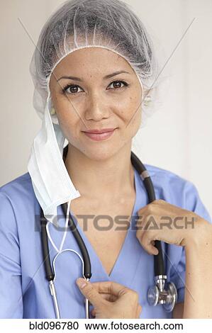 Stock Image - Mixed race doctor in scrubs. Fotosearch