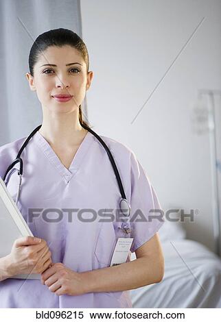 Stock Photography - Mixed race nurse standing in hospital. Fotosearch