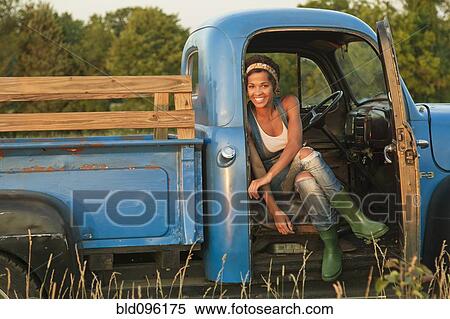 Mixed race woman sitting in old-fashioned truck View Large Photo Image Stock Photography - Mixed race woman sitting in old-fashioned truck. Fotosearch