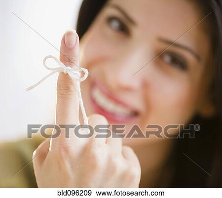 Mixed race woman with bow on her finger View Large Photo Image Stock Photo - Mixed race woman with bow on her finger. Fotosearch