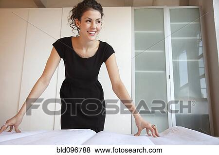 Smiling businesswoman checking blueprints View Large Photo Image Stock Photo - Smiling businesswoman checking blueprints. Fotosearch