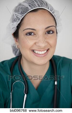 Smiling mixed race doctor in scrubs View Large Photo Image Stock Photo - Smiling mixed race doctor in scrubs. Fotosearch