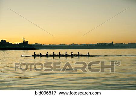 Team rowing boat in bay View Large Photo Image Stock Photo - Team rowing boat in bay. Fotosearch
