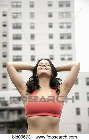 Stock Image - Woman in sportswear stretching outdoors. Fotosearch