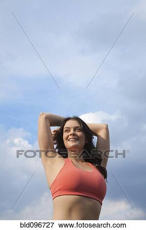 Woman in sportswear stretching outdoors View Large Photo Image Stock Photo - Woman in sportswear stretching outdoors. Fotosearch
