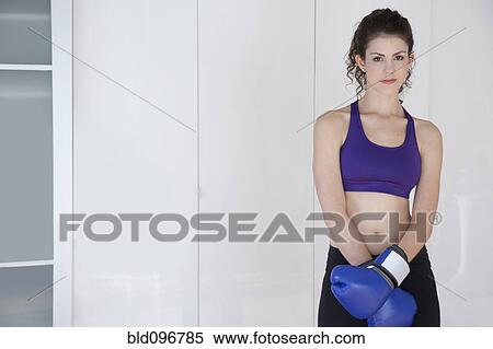 Stock Photography - Woman wearing boxing gloves. Fotosearch