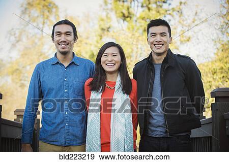 Adult Chinese siblings smiling outdoors View Large Photo Image Stock Photo - Adult Chinese siblings smiling outdoors. Fotosearch