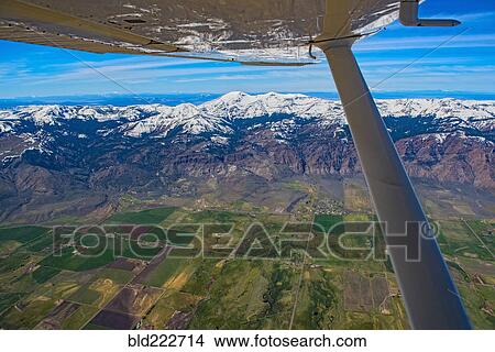 Picture - "Aerial view of airplane wing over Cedarville, California, United States, ". Fotosearch