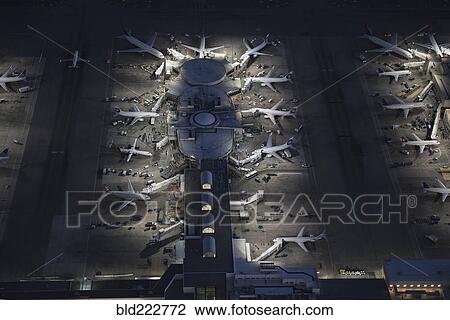 Stock Image - Aerial view of airplanes parked in airport gate. Fotosearch