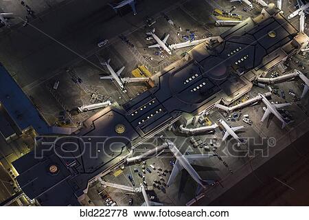 Stock Photo - Aerial view of airplanes parked in airport gates. Fotosearch