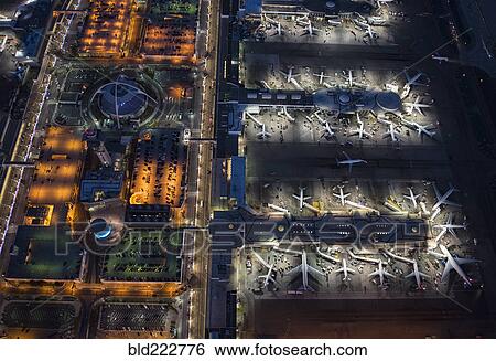 Stock Photograph - Aerial view of airplanes parked in airport gates. Fotosearch