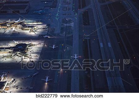 Stock Photo - Aerial view of airplanes taxing on airport runway. Fotosearch
