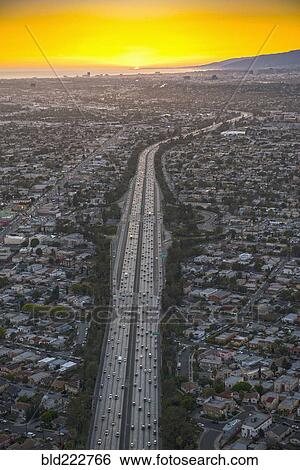 Stock Photograph - Aerial view of highway in suburban cityscape. Fotosearch
