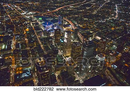 Stock Image - "Aerial view of Los Angeles cityscape lit up at night, California, United States". Fotosearch