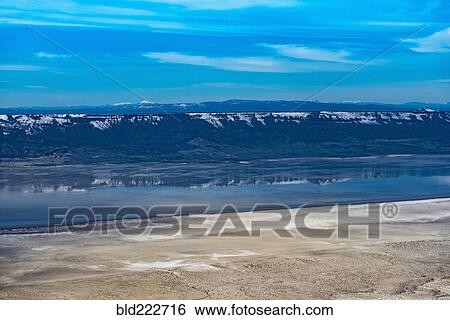 Stock Photograph - "Aerial view of mountains reflecting in lake, Paisley, Oregon, United States, ". Fotosearch