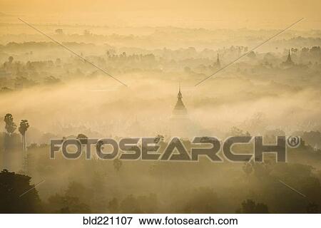 Stock Photo - Aerial view of towers in misty landscape. Fotosearch