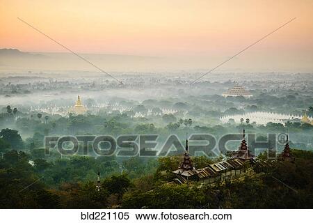 Stock Photography - Aerial view of towers in misty landscape. Fotosearch