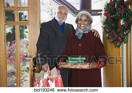 African American couple arriving with Christmas gifts View Large Photo Image Stock Photograph - African American couple arriving with Christmas gifts. Fotosearch