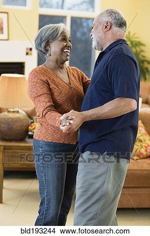 Picture - African American couple dancing in living room. Fotosearch