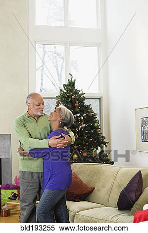 African American couple hugging near Christmas tree View Large Photo Image Stock Photography - African American couple hugging near Christmas tree. Fotosearch