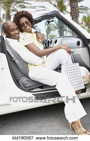 African American couple sitting in convertible View Large Photo Image Stock Photo - African American couple sitting in convertible. Fotosearch