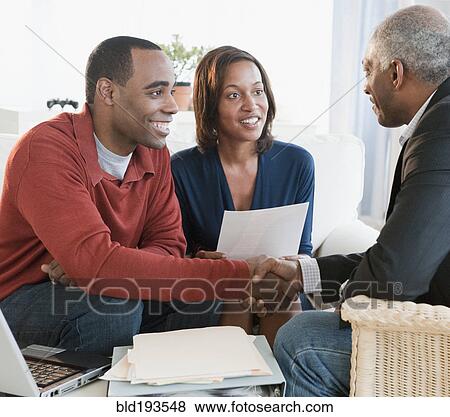 Stock Photo - African American couple talking with financial advisor. Fotosearch