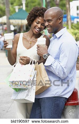 African American couple with shopping bags View Large Photo Image Stock Photo - African American couple with shopping bags. Fotosearch