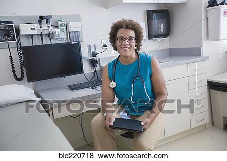 African American doctor holding digital tablet View Large Photo Image Stock Photo - African American doctor holding digital tablet. Fotosearch