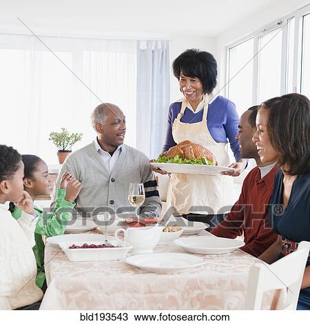 Stock Image - African American family about to enjoy Thanksgiving dinner. Fotosearch