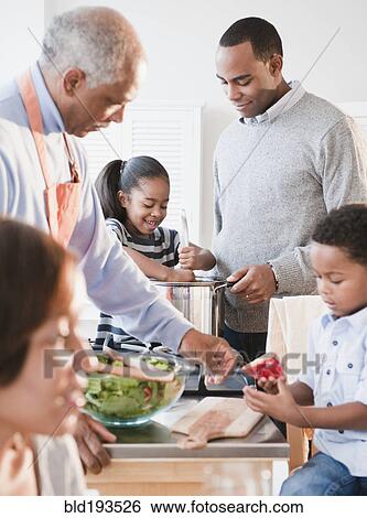 Stock Photograph - African American family cooking together. Fotosearch
