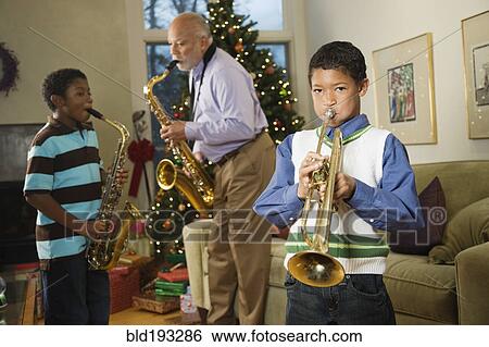 Stock Photograph - African American family playing musical instruments together. Fotosearch