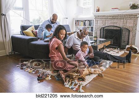 Stock Photography - African American family relaxing in living room. Fotosearch