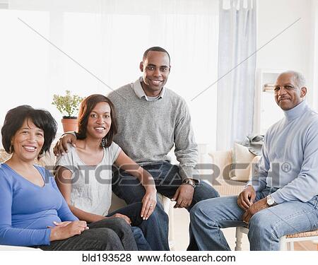 Stock Photo - African American family sitting in living room. Fotosearch