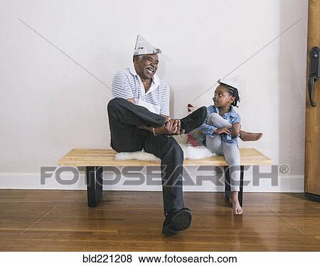 African American grandfather and granddaughter playing on bench View Large Photo Image Stock Photo - African American grandfather and granddaughter playing on bench. Fotosearch
