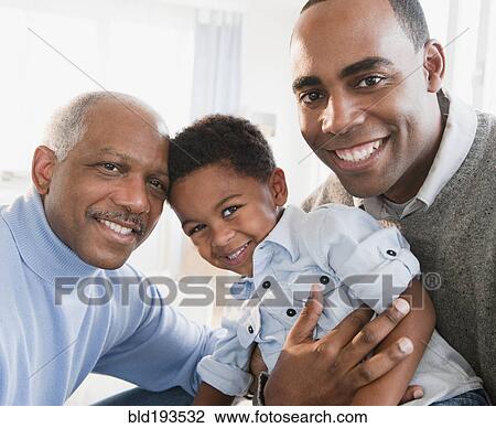 Stock Image - African American grandfather smiling with son and grandson. Fotosearch