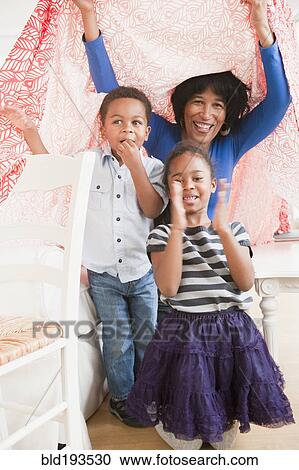 Stock Image - African American grandmother playing with grandchildren. Fotosearch