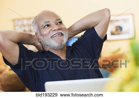 Stock Photo - African American man with hands behind head. Fotosearch