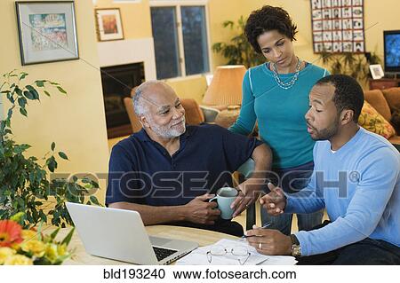 Stock Image - African American man with son and daughter talking. Fotosearch