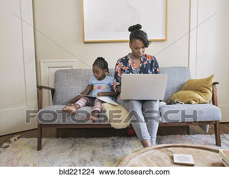 African American mother and daughter relaxing in living room View Large Photo Image Picture - African American mother and daughter relaxing in living room. Fotosearch